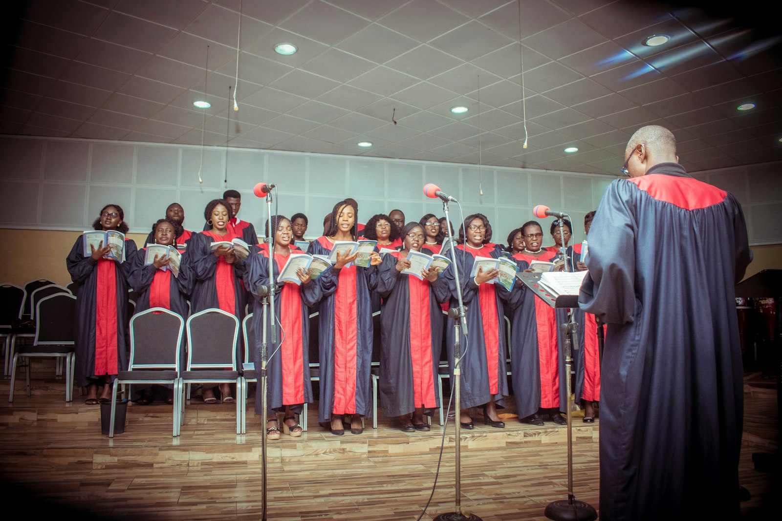 A choir in red robes singing together